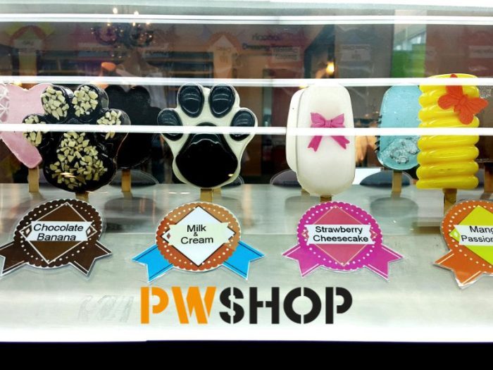 A mockup of a window element solution offered by PW Shop. Depicts various cakes and cookies in various flavours.