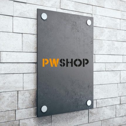 A charcoal effect acrylic wall mounted sign on a brick wall with the PW Shop logo emblazoned in the centre. Ecovista Signage by PW Shop.