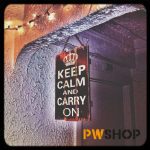 An EcoVista signage solution by PW Shop. A mockup of the classic 'Keep Calm and Carry On' sign hanging in an archway.