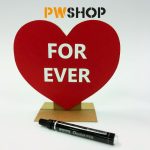 A red 'Sweetheart' stand popup decoration with 'Forever' written on it. A black sharpie pen laying next to it. PW Shop logo is also visible.